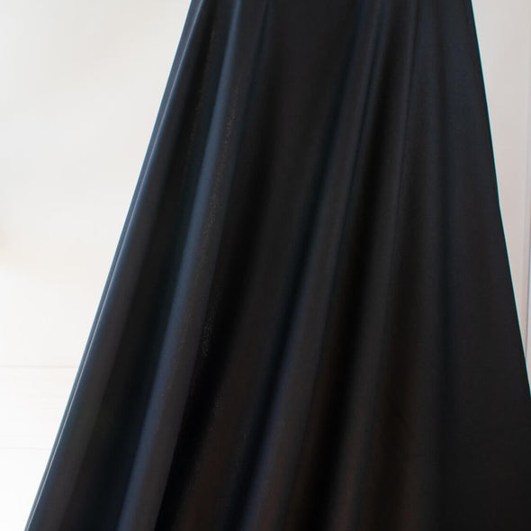 Transform this high-end designer Ponte knit into pure fabulous.  Whether you have a little black dress in mind, a pencil skirt, or jacket you'll exude confidence and sophistication when you walk in the room. You'll love the soft touch of the fabric and the comfort of it's stretch. Image of fabric drape.