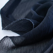 High End Designer label 100% Silk Chiffon in a very dark navy at a generous width. Chiffon is sheer, has a beautiful drape and is popular in blouses, gowns, lingerie, flowy overlays, scarves, even trim. Perhaps you have seen it used as trim in those fabulous French Jackets! A technique we can't wait to try. Photo of selvedge.