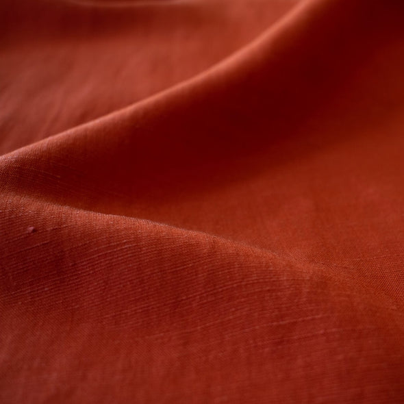 Richly saturated in color, this linen blend has a soft, textured hand and the familiar drape of rayon. Make up a gorgeous top, dress or skirt that stands out!  Translucent with a pleasing slubbed texture, may need lining for dresses and skirts. Close up image.