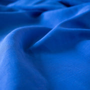 You'll be feeling the summer vibes in this Polynesian blue linen blend.  It has a soft, textured hand and the familiar drape of rayon. Make up a gorgeous top, dress or skirt that stands out!  Translucent with a pleasing slubbed texture, may need lining for dresses and skirts. Close up image.