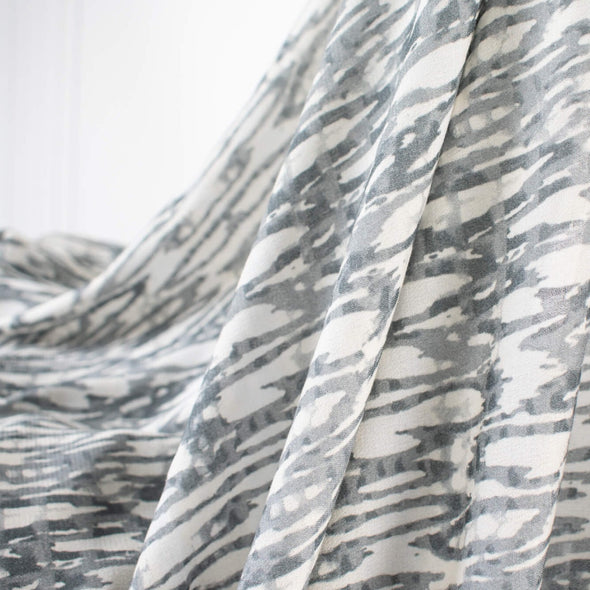 Photo showing fabric lengthwise drape. Soft animal print in a sophisticated palette of eggshell and shades of grey from a Los Angeles designer.