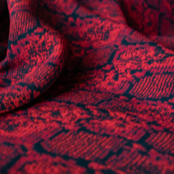 Whip yourself a stunning dress or top in this sophisticated designer deadstock animal print with a stunning red background. Photo of fabric design .