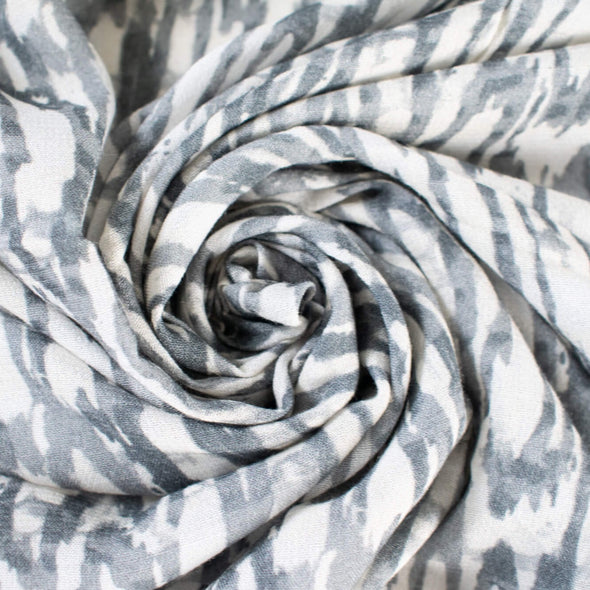 Close up photo showing fabric fullness. Soft animal print in a sophisticated palette of eggshell and shades of grey from a Los Angeles designer.