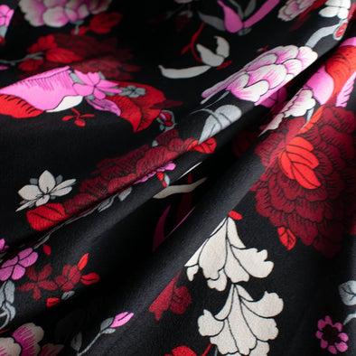 Create something stunning with this Designer Silk Crepe de Chine in florals of pinks, red, white, burgundy and grey upon a black background. Photo depicts fabric body.