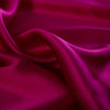 Simply stunning razzleberry pink charmeuse from a high end designer label 100% silk in a generous 52 inch width. Charmeuse is a popular fabric for creating fluid bias cut garments and luxurious lining to your special pieces like the French Jacket. Photo demonstrating fabric body.
