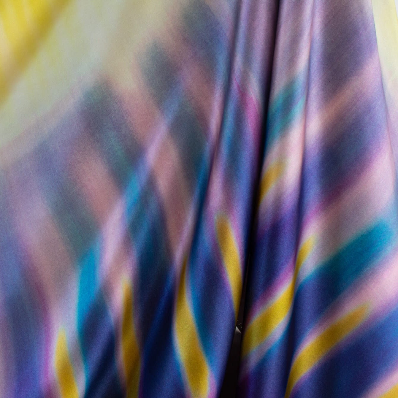 Los Angeles Designer 100% Silk Charmeuse in a modern and fun Tie Dye print! Have fun turning your creation into a sophisticated kaleidescope of color! Photo shows drape of fabric