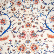 Silky rayon floral jacobean print . A vine in a gorgeous shade of electric blue trails through florals of various shades of peach, red and blue. Overall print design photo.