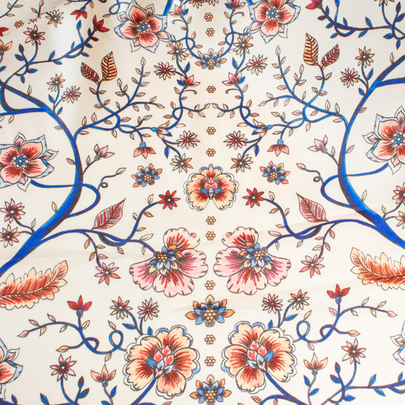 Silky rayon floral jacobean print . A vine in a gorgeous shade of electric blue trails through florals of various shades of peach, red and blue. Overall print design photo.