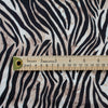 Famous Designer Rayon Challis flowy and soft animal print in tan white and black. Photo with ruler to show fabric print size.
