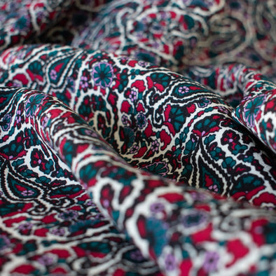 French Designer Is@bel M@rant - Paisley Italian Viscose Crepe - 'Isabel'  Shop the same Italian mills the designers are with this stunning Italian viscose crepe. A sophisticated paisley in shades of green, red and a light 'peri', over an ivory background is just sublime.  Close up image.