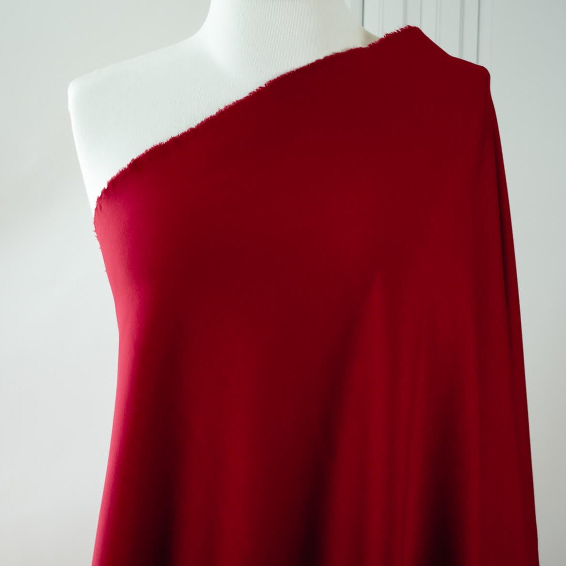 High-end designer Ponte knit in a gorgeous dark red. Create a stylish pencil skirt or make a bold statement in a red dress, either way you'll look fabulous! You'll love the soft touch of the fabric and the comfort of it's stretch. Fabric draped on dressform.