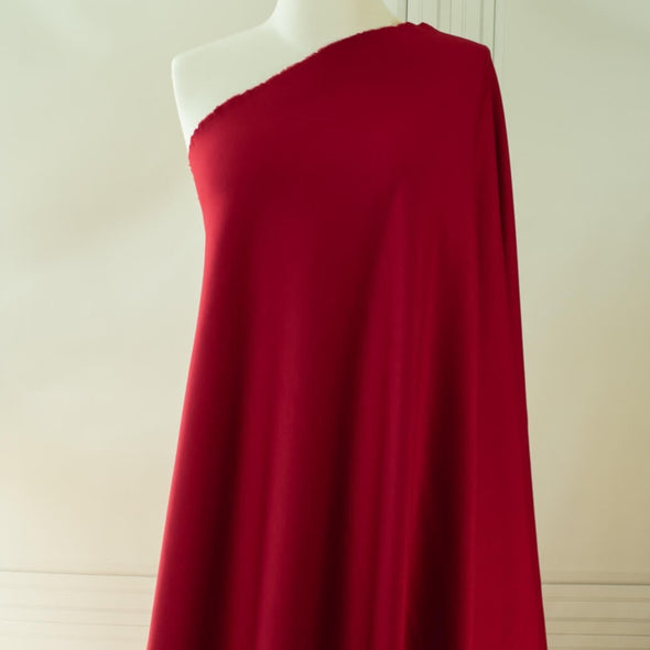 High-end designer Ponte knit in a gorgeous dark red. Create a stylish pencil skirt or make a bold statement in a red dress, either way you'll look fabulous! You'll love the soft touch of the fabric and the comfort of it's stretch. Fabric draped on dressform.