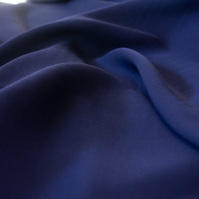 A 100% silk double georgette by a NYC designer is sure to capture attention with its flowy drape and textured hand.   closeup image