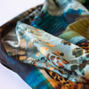 Shades of Turquoise, golden flecks and subtle animal print adorn this beautiful digital print knit. Make a gorgeous and versatile wrap top or dress! Close up photo.