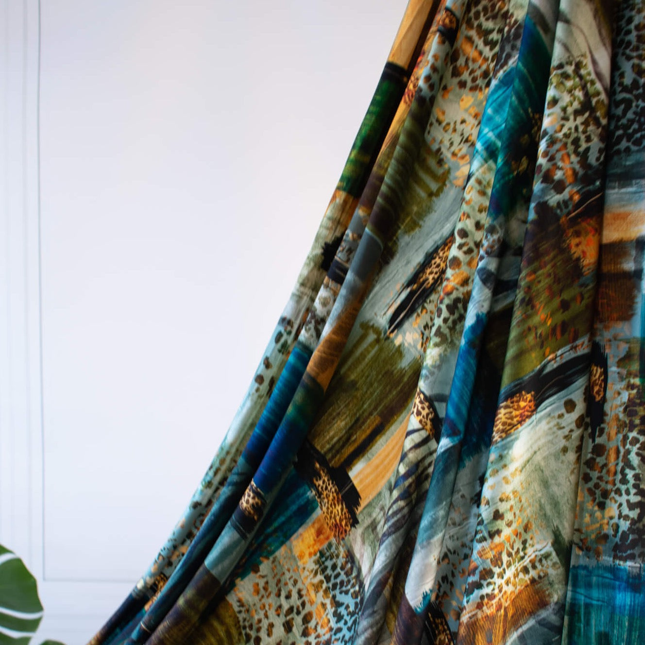 Shades of Turquoise, golden flecks and subtle animal print adorn this beautiful digital print knit. Make a gorgeous and versatile wrap top or dress! Photo of lengthwise drape.