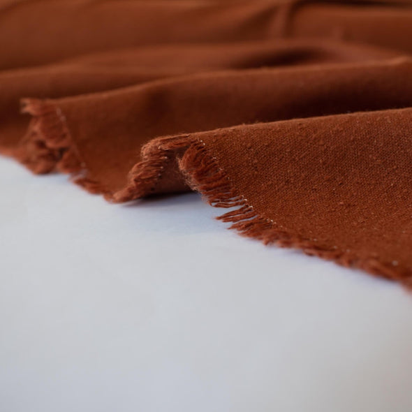 LA Designer silk noil in a gorgeous ginger color. A nice fabric for tailored and loose-fitting styles!  Perfect for a wide-leg  pant, or a tailored shirt dress or casual jacket.  Image of selvedge.