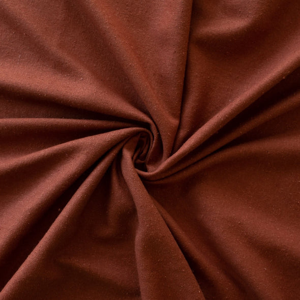LA Designer silk noil in a gorgeous ginger color. A nice fabric for tailored and loose-fitting styles!  Perfect for a wide-leg  pant, or a tailored shirt dress or casual jacket.  Image  of fabric body.