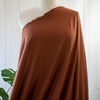 LA Designer silk noil in a gorgeous ginger color. A nice fabric for tailored and loose-fitting styles!  Perfect for a wide-leg  pant, or a tailored shirt dress or casual jacket.  Image - fabric draped on mannequin.