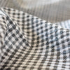 Gingham never looked so good!  Designer, black and white stretch woven has a dobby weave creating a geometric pattern which transforms the fabric into something truly special. This fabric has bit of a vintage vibe and is soft with a textured pattern and stretch along the selvedge.  close up image