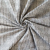 Gingham never looked so good!  Designer, black and white stretch woven has a dobby weave creating a geometric pattern which transforms the fabric into something truly special. This fabric has bit of a vintage vibe and is soft with a textured pattern and stretch along the selvedge.  Image of fabric body.