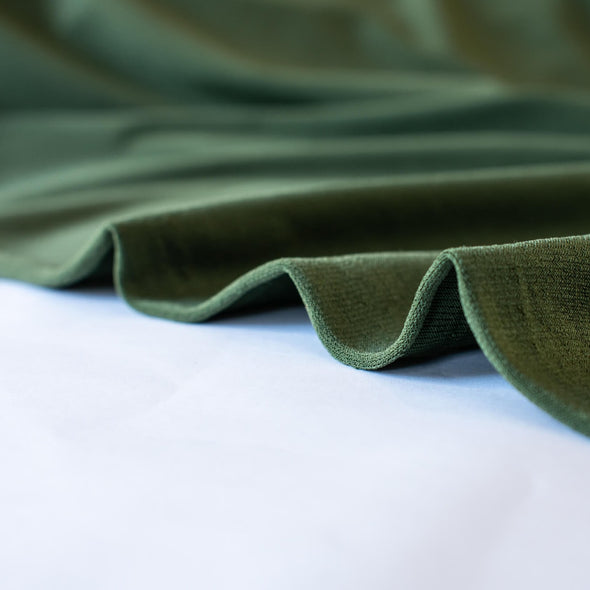 Designer ITY knit with a soft hand and fluid drape.  Perfect for wrap dresses or tops.  This knit has nice weight, it's light but it's not a slinky knit.  If you're just starting to work with ITY knits you will love how this sews up!   Image of selvedge.