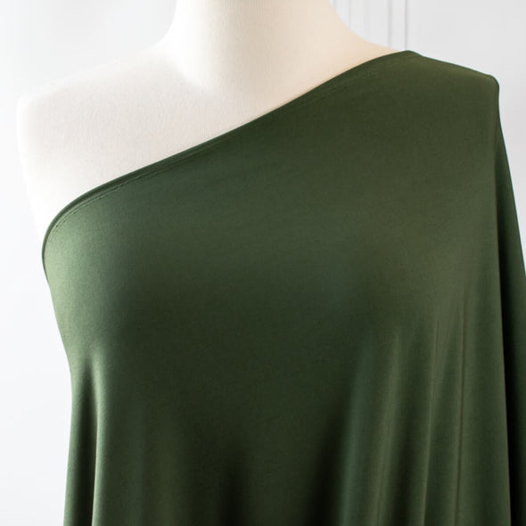 Designer ITY knit with a soft hand and fluid drape.  Perfect for wrap dresses or tops.  This knit has nice weight, it's light but it's not a slinky knit.  If you're just starting to work with ITY knits you will love how this sews up!   Image of fabric on dressform.