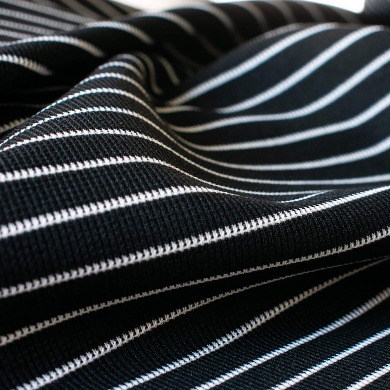 This soft semi-textured double knit imported from ITALY is such a versatile fabric choice. This classic stripe is stunning whether you are crafting a cardigan or whipping up a top or dress. Close up photo.