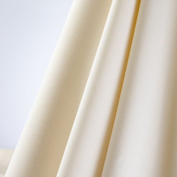 Create something stunning in this timeless Italian double weave stretch suiting.  Soft with a semi-textured hand in a sophisticated eggshell/ivory color.  This is definitely a great fabric to build a classic wardrobe!  Think wide leg pant and tailored jacket!  Image of fabric drape.