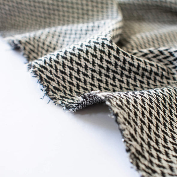 Italian Herringbone Sweater Knit with Metallic Threads -Wide. Image of selvedge.