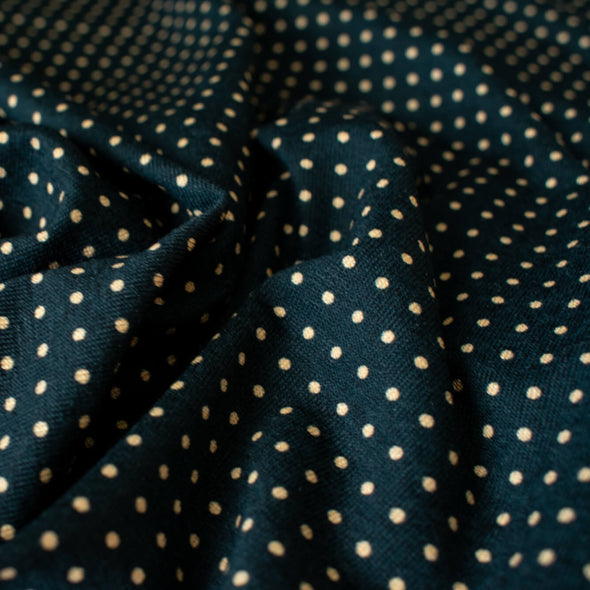 Imported from Italy, soft jersey knit in a classic polka dot fashion. Dark navy and tan, perfect for an iconic classic wrap dress! Close up photo.