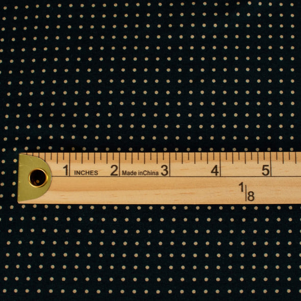 Imported from Italy, soft jersey knit in a classic navy and tan polka dot fashion. Perfect for an iconic classic wrap dress! Photo of fabrics design scale with ruler.