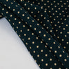 Imported from Italy, soft jersey knit in a classic polka dot fashion. Dark navy and tan, perfect for an iconic classic wrap dress! Photo of fabric edge.
