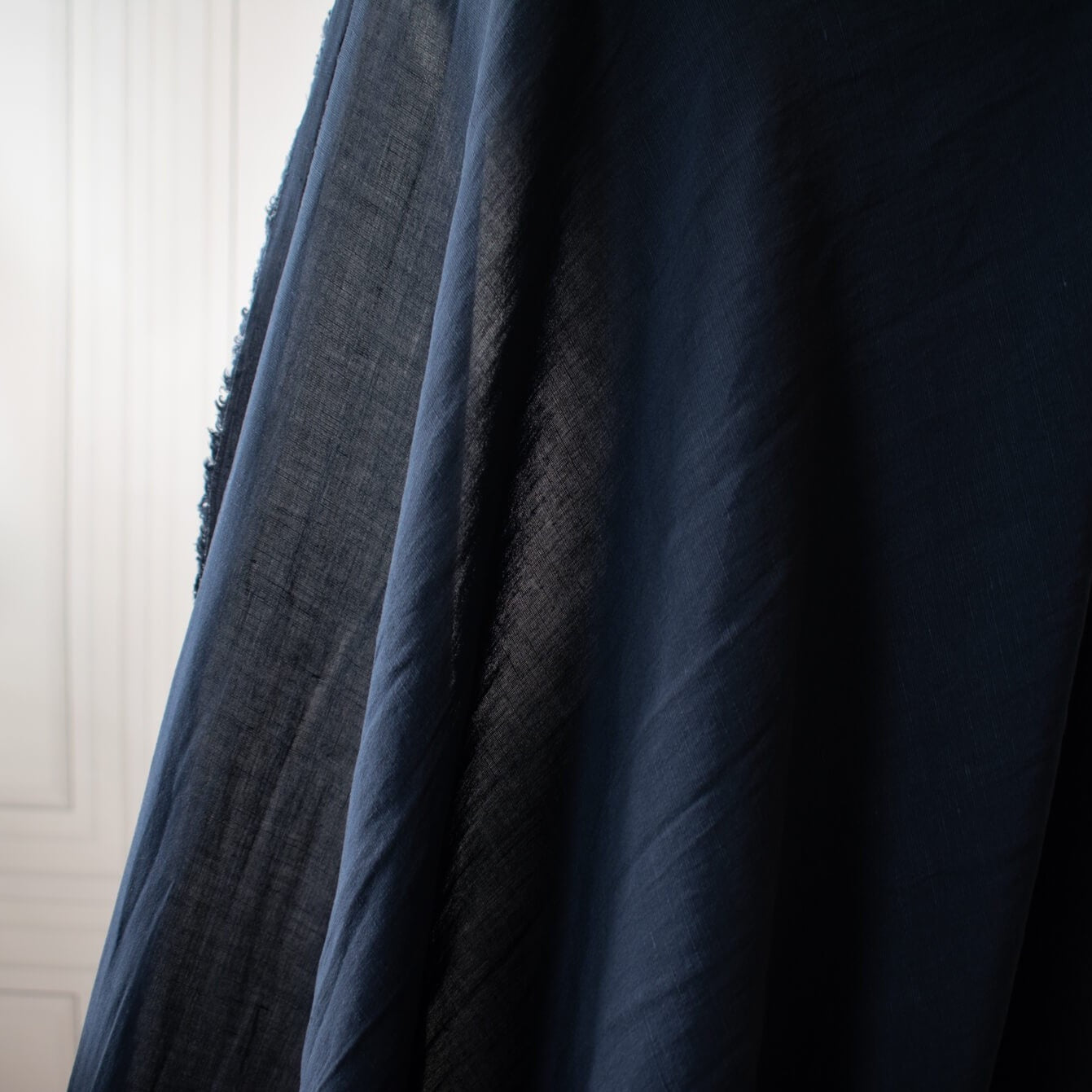 Richly saturated in color, this linen blend has a soft, textured hand and the familiar drape of rayon. Make up a gorgeous top, dress or skirt that stands out!  Translucent with a pleasing slubbed texture, may need lining for dresses and skirts.   Close up on fabric drape.