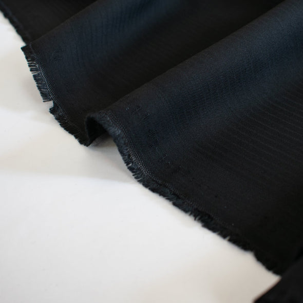 A tropical wool suiting will take you anywhere, especially when it's from a couture designer to Hollywood stars! This black woven striped fabric is a bit translucent so you will need lining if you are making a suit or dress.