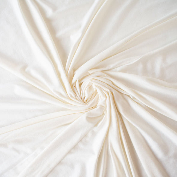 Casual and elegant, perfect for the popular flowy cardigan or wide leg pant.  Off white tissue jersey knit that is soft and flowy. Very thin hand, light and translucent from a Los Angeles designer. Image of fabric 