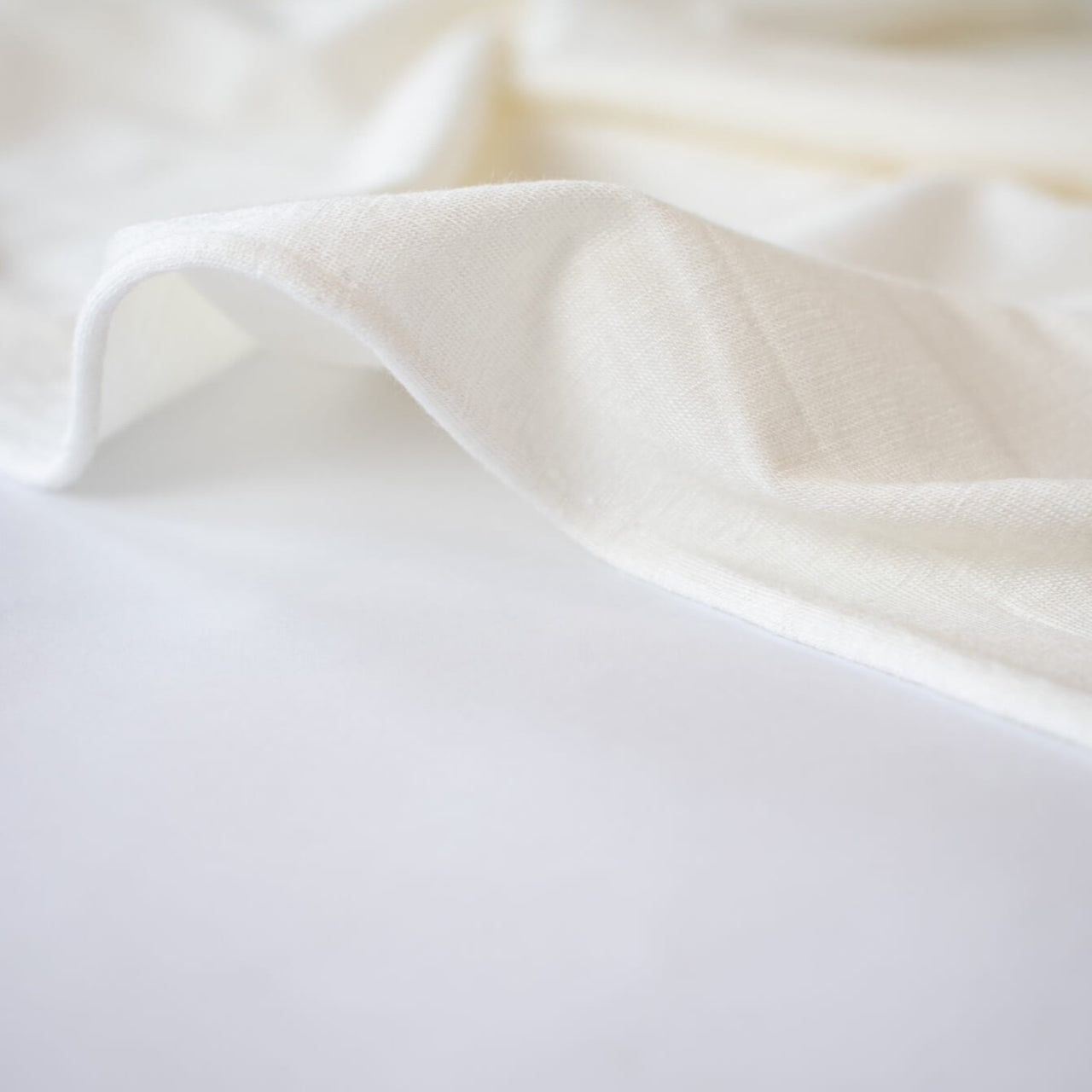 Casual and elegant, perfect for the popular flowy cardigan or wide leg pant.  Off white tissue jersey knit that is soft and flowy. Very thin hand, light and translucent from a Los Angeles designer. Close up of selvedge