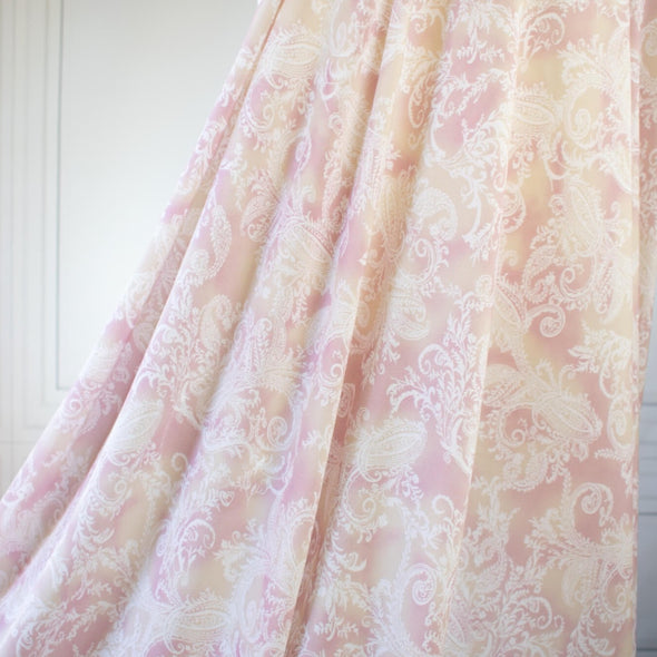 The soft pale rose and cream background with a white paisley print gives it a hint of 'Boho' vibe that's so L.A.    You'll look gorgeous in one of the popular flowy dresses or pants.  Or, if you prefer a sleeker look, this is a bias cut slip dress waiting to happen. Image of fabric drape.