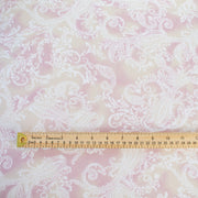 The soft pale rose and cream background with a white paisley print gives it a hint of 'Boho' vibe that's so L.A.    You'll look gorgeous in one of the popular flowy dresses or pants.  Or, if you prefer a sleeker look, this is a bias cut slip dress waiting to happen. Image of fabric with ruler for scale.