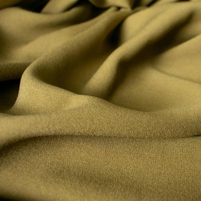 NYC Designer Couture silk crepe de chine in a fantastic width. This mustard green color will bring any of your neutrals a great pop of color! Closeup photo