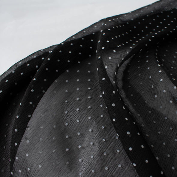Classic black and off white polka dot is always elegant! Chiffon is sheer, has a beautiful drape and is popular in blouses, gowns, lingerie, flowy overlays, scarves, even trim. Perhaps you have seen it used as trim in those fabulous French Jackets! Photo shows fabric transparency.