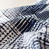 Modern, smooth and a dream to sew! This white and navy abstract plaid techno knit is not as thick as a scuba knit but does lay gently over our curves.  Choose this fabric as you would a double knit as it does have some fullness. Perfect for a pencil skirt, fitted sheath dress or a top. Close up image.