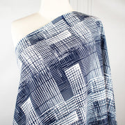 Modern, smooth and a dream to sew! This white and navy abstract plaid techno knit is not as thick as a scuba knit but does lay gently over our curves.  Choose this fabric as you would a double knit as it does have some fullness. Perfect for a pencil skirt, fitted sheath dress or a top. Image of fabric on dressform