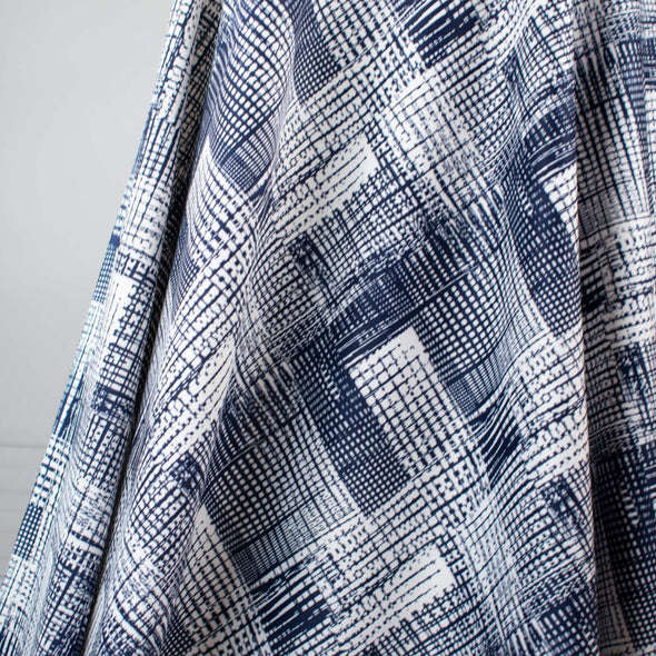 Modern, smooth and a dream to sew! This white and navy abstract plaid techno knit is not as thick as a scuba knit but does lay gently over our curves.  Choose this fabric as you would a double knit as it does have some fullness. Perfect for a pencil skirt, fitted sheath dress or a top. Image of fabric drape.
