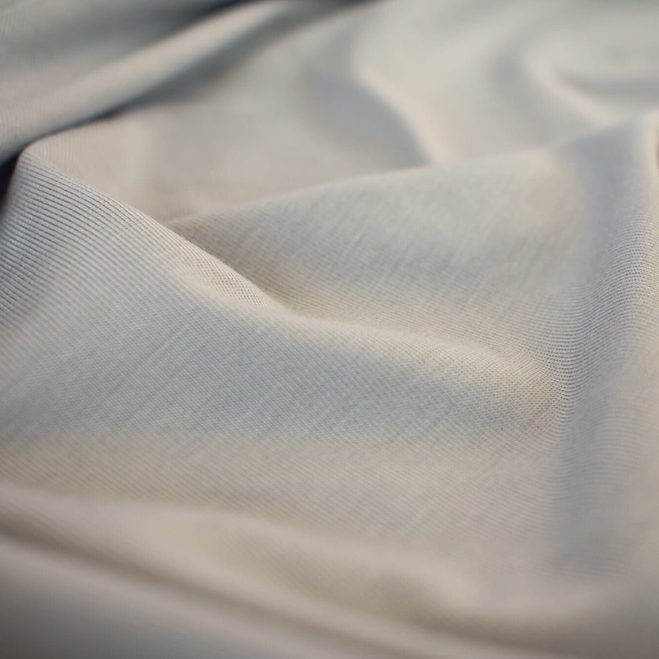 Wonderfully soft light grey jersey knit from a New York designer has a light and flowy hand. Create a luxurious top or dress that feels dreamy to the touch.  Sew up a favorite T-Shirt or your favorite loungewear...it will just make you feel happy! close up image