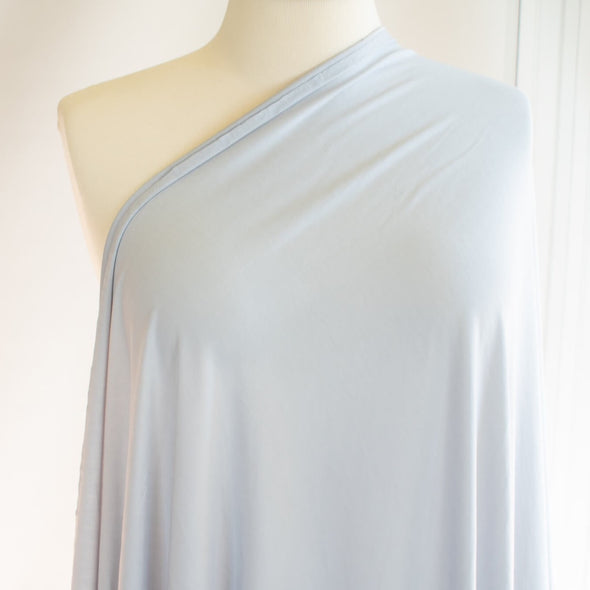 Wonderfully soft light grey jersey knit from a New York designer has a light and flowy hand. Create a luxurious top or dress that feels dreamy to the touch.  Sew up a favorite T-Shirt or your favorite loungewear...it will just make you feel happy! image of fabric drape
