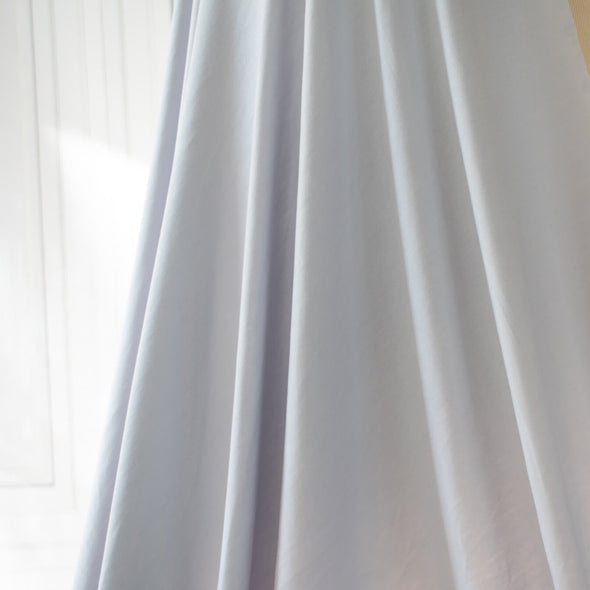 Wonderfully soft light grey jersey knit from a New York designer has a light and flowy hand. Create a luxurious top or dress that feels dreamy to the touch.  Sew up a favorite T-Shirt or your favorite loungewear...it will just make you feel happy! Image of fabric Drape.