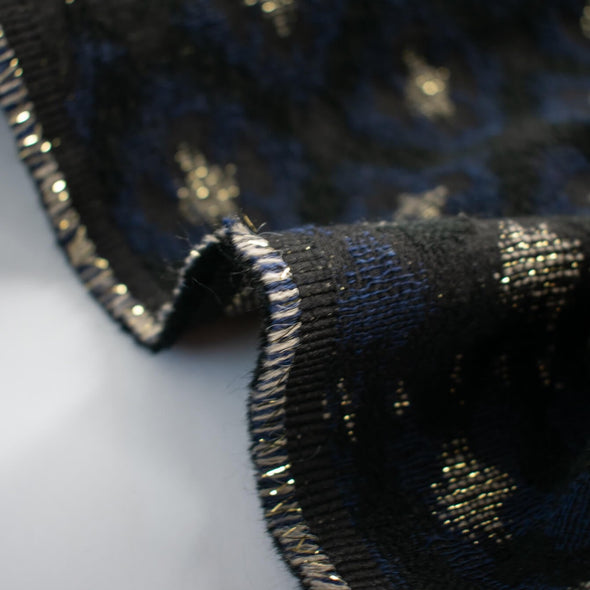 The golden metallic threads of this Italian jacquard create a diamond pattern, bordered in a black diamond shape that is just stunning.  A soft textured hand and medium weight make it perfect for a stylish jacket! Image of selvedge edge.