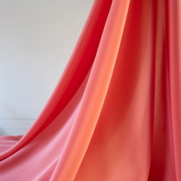 Universally flattering, salmon pink crepe de chine. The soft, semi-textured fluid drape will create a lovely dress or top for your next sewing adventure. image of drape.