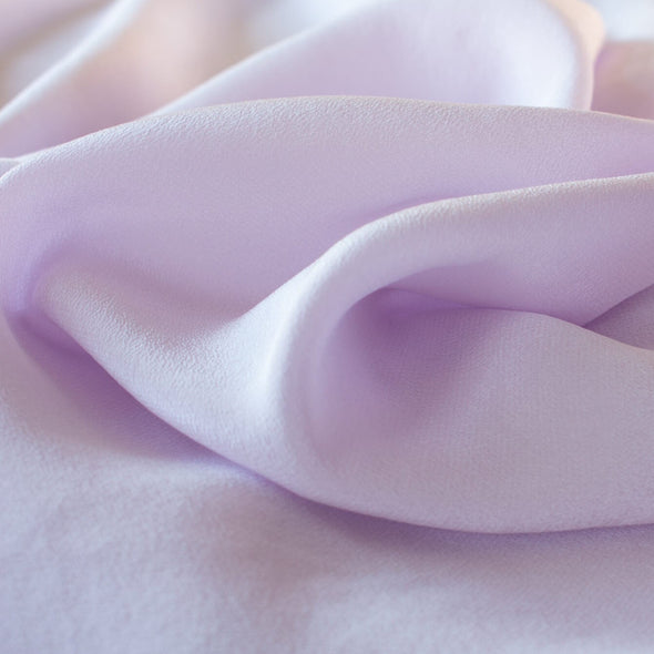 Dreamy Wisteria Purple 100% Silk Crepe de Chine ...brings to mind the first spring blooms. Create a lovely top or dress in this soft color that is versatile and flattering. Close up photo.