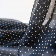 Add elegance to your project with this lovely black and Vanilla Creme 100% Silk Polka Dot Chiffon. Chiffon is sheer, has a beautiful drape and is popular in blouses, gowns, lingerie, flowy overlays, scarves, even trim. Perhaps you have seen it used as trim in those fabulous French Jackets! A technique we can't wait to try. Photo revealing sheerness of this fine fabric.